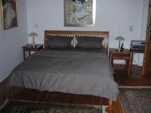 a bedroom with a large bed with two night stands at My sweet home in Sauerlach