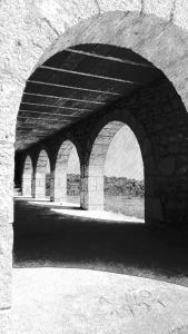 a black and white photo of a stone bridge at La Conquesta de Culla in Culla