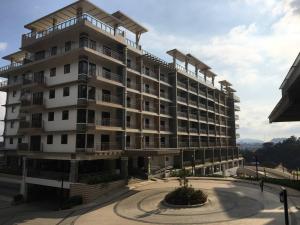 a large apartment building with a courtyard in front of it at Bristle Ridge Residences - Oakhill in Baguio