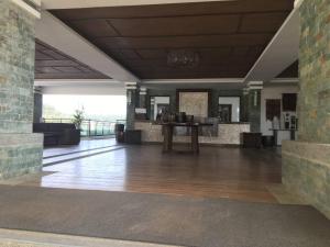 a lobby with a table in the middle of a building at Bristle Ridge Residences - Oakhill in Baguio