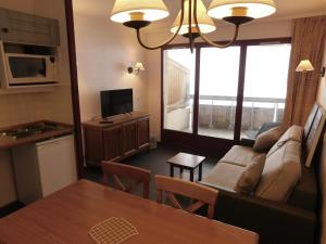 a living room with a couch and a table at Les Terrasses d Azur in Isola 2000