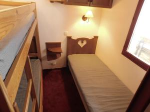 a small room with two bunk beds and a window at Les Terrasses d Azur in Isola 2000 +9 photos