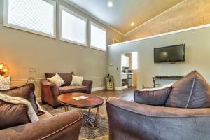 a living room with couches and a flat screen tv at Bella Casa - Loft in Moab