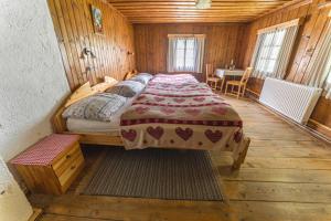 a bedroom with a bed in a wooden room at Obervostlhaus - Sehr schöne gemütliche Almhütte der besonderen Art in Ebene Reichenau