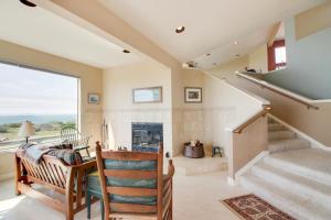 a living room with stairs and a fireplace at Levy Retreat in Sea Ranch