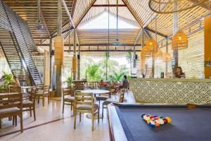 a restaurant with a pool table and tables and chairs at Selina Nosara in Nosara