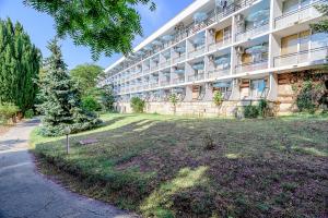 an apartment building with a large yard in front of it at International House of Journalists Resort in Golden Sands