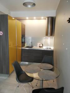 a kitchen with a table and chairs in a kitchen at Art Academy Apartment in Tallinn