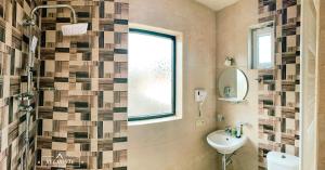a bathroom with a sink and a window at Belmonte Kazbegi in Kazbegi