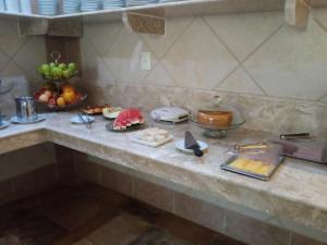 a kitchen counter with a bunch of food on it at Hotel Porto Belo in Aquiraz