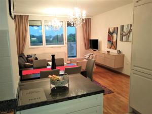 a kitchen and living room with a dining room at Orange Apartment in Sarajevo