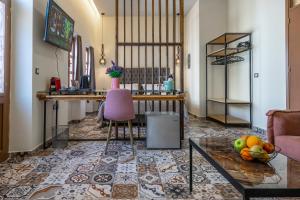 a living room with a table and a bowl of fruit on the floor at Casa Poli Suites in Rhodes Town