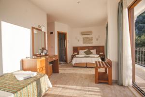 a hotel room with a bed and a balcony at Medusa Hotel in Kas +102 photos