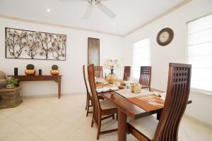 a dining room with a wooden table and chairs at Battaleys Mews 22 in Saint Peter