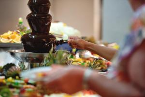 a person is holding a group of food on a table at Sotavento Beach Club in Costa Calma
