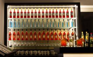 a bar with a bunch of bottles of alcohol at Lizz Hotel Munich in Munich