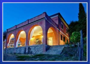 a building with arches and stairs in front of it at Agriturismo Cerrolungo in La Spezia