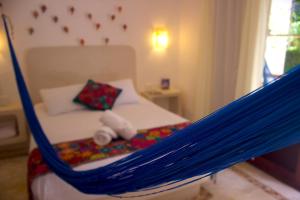 Postel nebo postele na pokoji v ubytování Casa Iguana Holbox - Beachfront Hotel