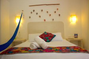 Postel nebo postele na pokoji v ubytování Casa Iguana Holbox - Beachfront Hotel