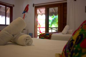 Postel nebo postele na pokoji v ubytování Casa Iguana Holbox - Beachfront Hotel