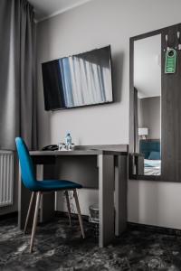 
a room with a desk and a chair in it at Hotel Sleep Wrocław in Wrocław
