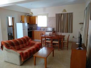 a living room with a couch and a table at Kapsalia Holiday Villas in Pissouri