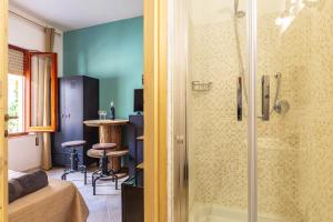 a bathroom with a shower with a glass door at bedbike Baunei in Baunei +47 photos