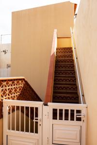 a stairway with two white gates and a staircase at Casita de playa in Puertito de Güímar