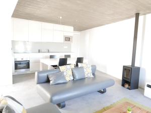sala de estar con sofá azul y cocina en Casa na Carrapateira, Aljezur en Carrapateira