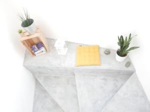 a bathroom counter with towels and plants on it at Casa na Carrapateira, Aljezur in Carrapateira