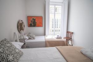 Łóżko lub łóżka w pokoju w obiekcie Apartamentos Las Musas de Cadiz