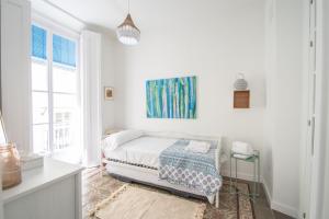 Łóżko lub łóżka w pokoju w obiekcie Apartamentos Las Musas de Cadiz