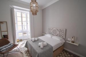Łóżko lub łóżka w pokoju w obiekcie Apartamentos Las Musas de Cadiz