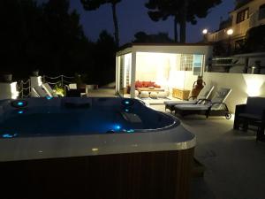 a jacuzzi tub on a patio at night at Residence Maresol in Vieste