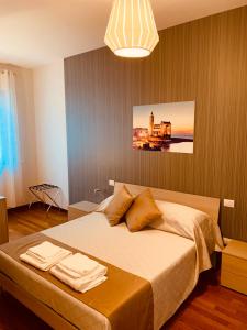 a bedroom with a bed with towels on it at Berga Exclusive Suite 3 in Bari