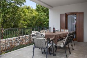 a dining room table and chairs on a balcony at Villa Marko in Kras