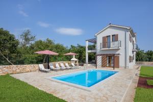 a villa with a swimming pool and a house at Villa Marko in Kras