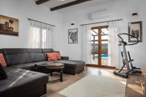a living room with a couch and a exercise bike at Villa Marko in Kras