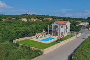 an aerial view of a house with a swimming pool at Villa Marko in Kras