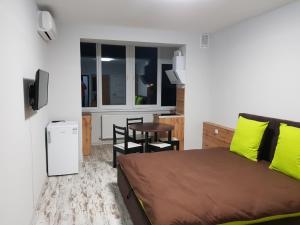 a bedroom with a bed and a table in a room at Silver Star Apartment 40b in Uzhhorod