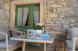 a table with a vase of flowers on a patio at Apartment Duerose in Buje