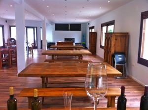 a room with wooden tables and wine glasses at Finca Seguró in Sella