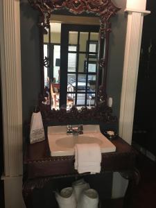 a bathroom with a sink with a mirror and towels at Park Place in Fort Worth