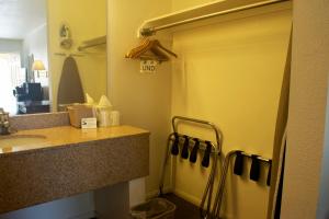 a bathroom with a sink and a mirror at Rio Del Sol Inn Needles in Needles