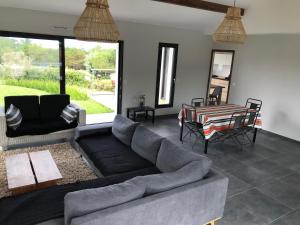a living room with a couch and a table at Villa avec piscine privée, vue sur mer et plage à pied 800m in Saint-Jean-de-Luz