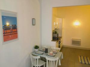 a dining room with a table and chairs in a room at In the heart of Old Nice - 2min. from Cours Saleya and Promenade des Anglais in Nice