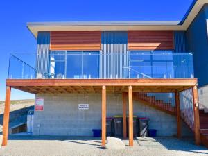 a building with a balcony on top of it at Alpine View Apartment 1 - Tekapo in Lake Tekapo +3 photos