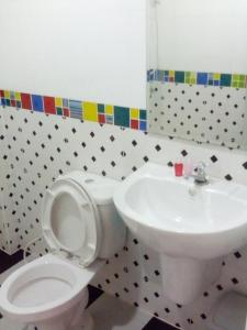 a bathroom with a white toilet and a sink at Ocean View Resort - Koh Sichang in Ko Si Chang