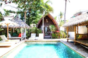 a resort with a swimming pool and a house at Unzipp Lumbung Gili Trawangan in Gili Trawangan +61 photos