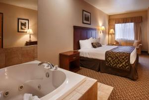a hotel room with a bath tub and a bed at The Montcler Hotel - Redberri Luxury Collection in Sandwich +42 photos